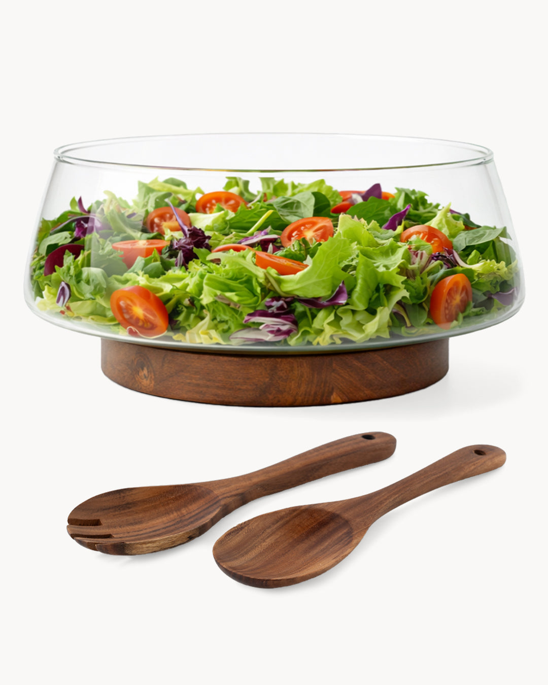 Ensaladera de vidrio con cubiertos de ensalada y soporte